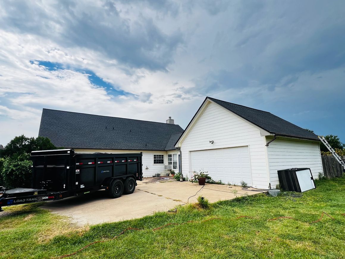 GRS Roofing — roof replacement on a white house